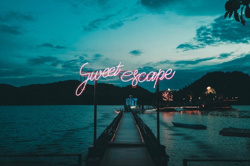 a tropical island with a sign saying sweet escape